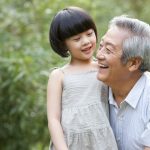 Grandpa and grandaughter having fun in garden